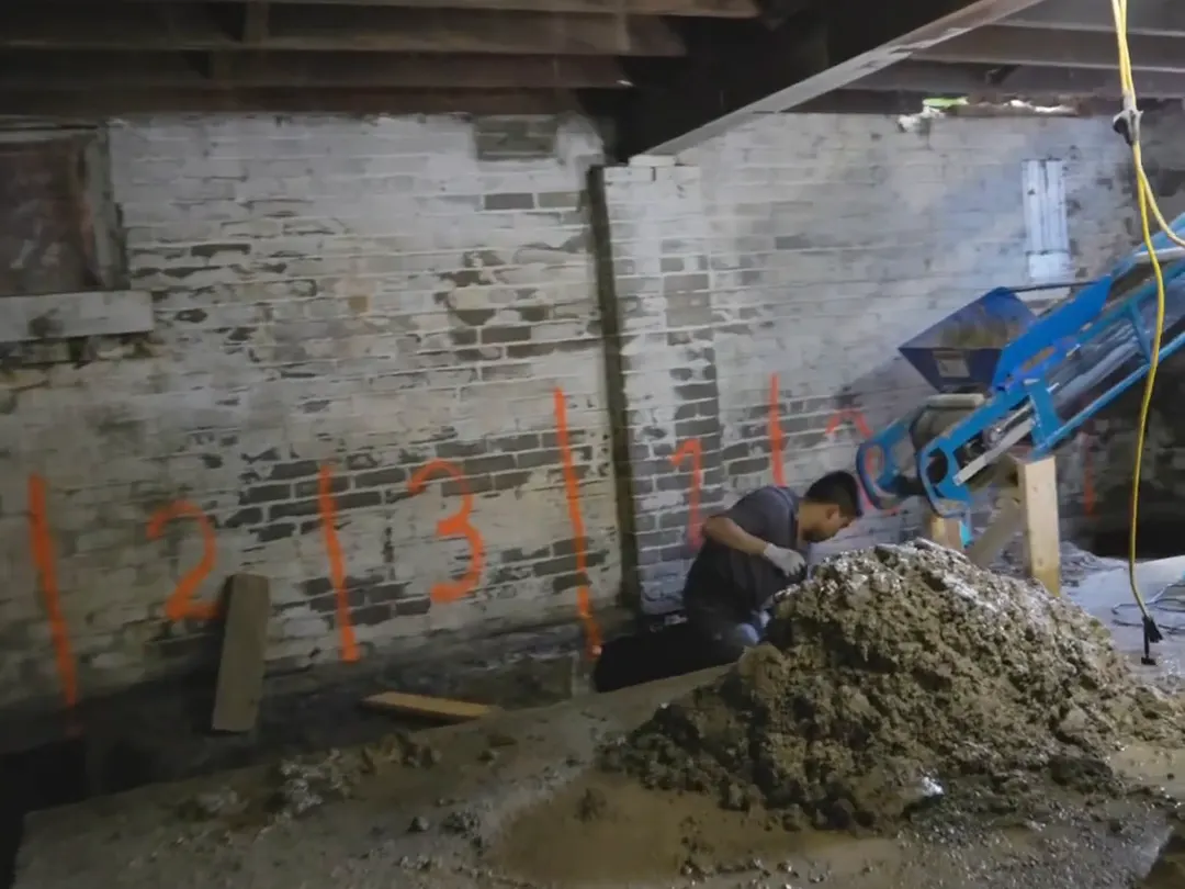 Numbered underpinning sections marked in orange on a brick foundation wall during a Toronto basement project
