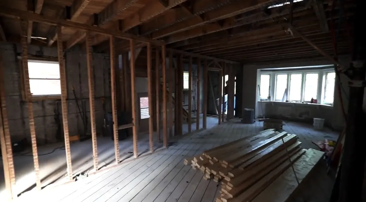 House interior stripped back to the studs and floorboards, ready for renovation