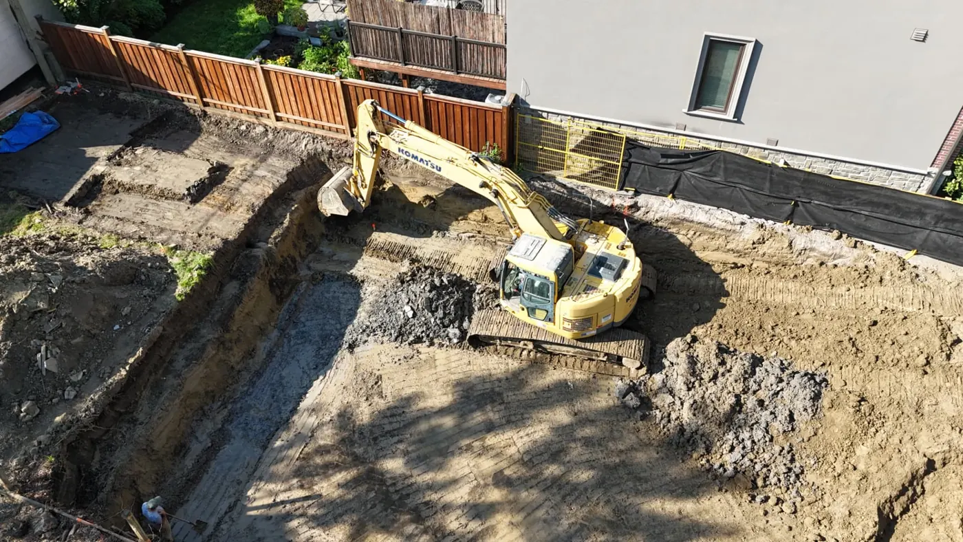 Drone view of a Pinemar excavator digging a residential foundation