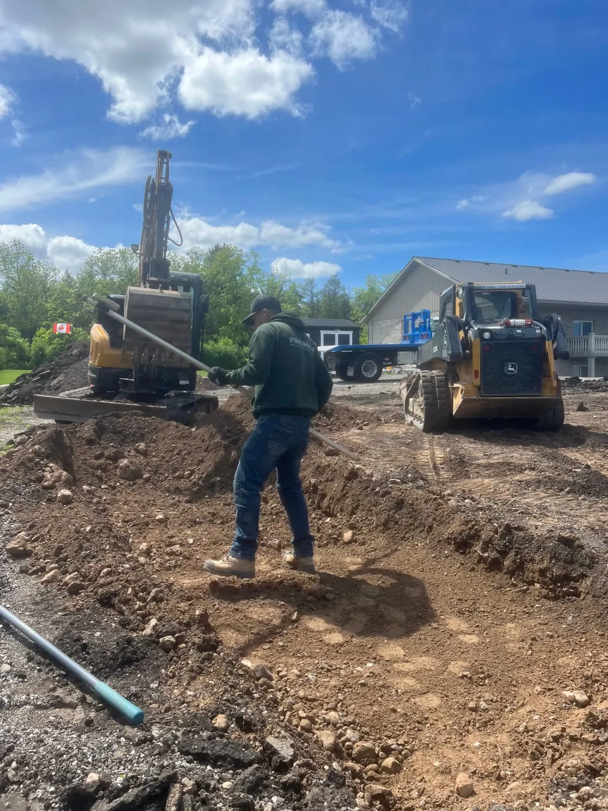 Pinemar crew spreading and grading soil with a compact excavator and skid steer